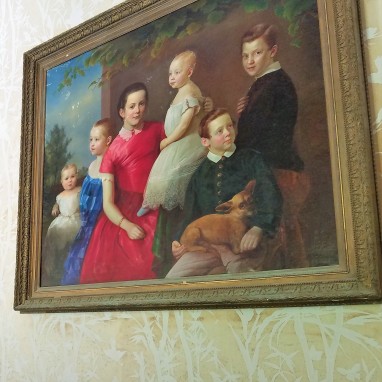 The girl in red is believed to be the young portrait of Annie Palmer, while the other children were added because she doesn't like children.